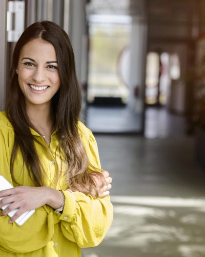 portrait-of-young-businesswoman-in-office-atrium-2023-11-27-05-07-16-utc-min